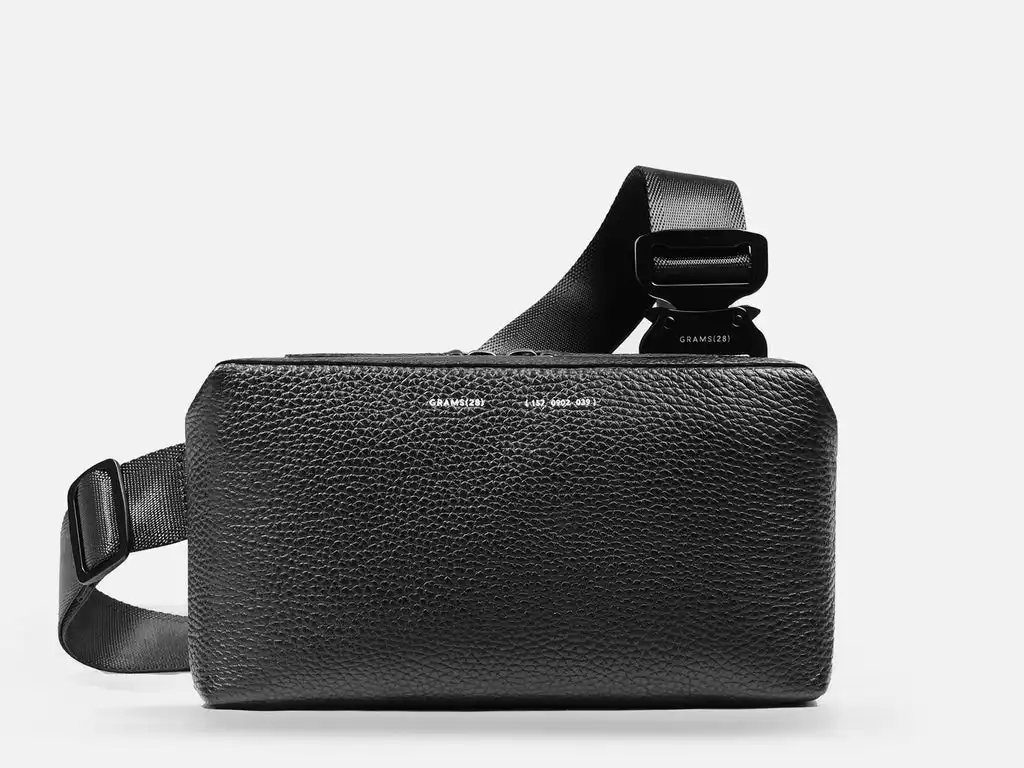 Grams28 157 Essential Sling - A slim leather sling that holds a phone, wallet, and keys without feeling like a bag